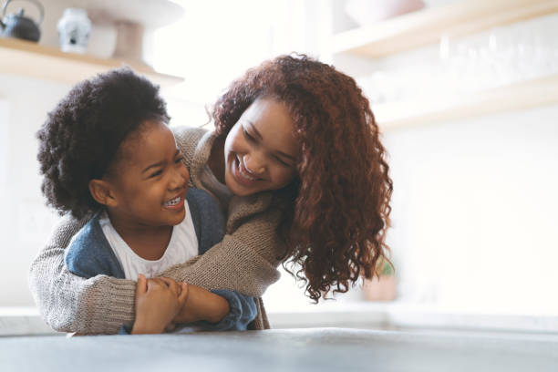istock Happy mother embracing daughter in kitchen 926171534