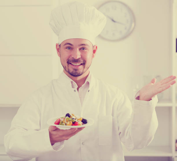istock Smiling chief showig greek salad 926171894