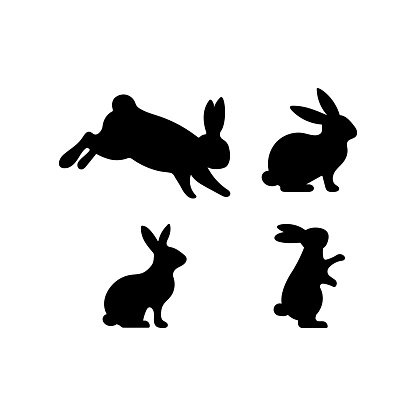 A set of Easter rabbits silhouette in different shapes and actions isolated on a white background.