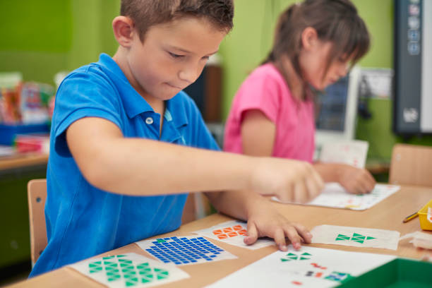 istock Schoolboy with colorful stickers doing art project 926172702