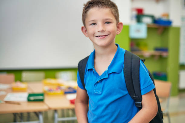 istock Portrait of schoolboy smiling in classroom 926172704