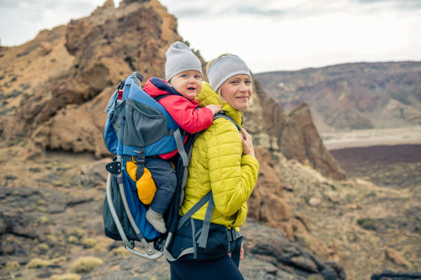 istock Family hike, mother with baby in backpack 926181948