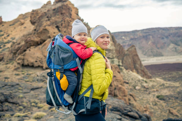 istock Family hike, mother with baby in backpack 926182452