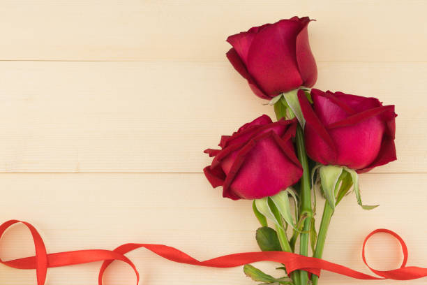 istock Red roses bouquet decorated with wave red ribbon 926185410
