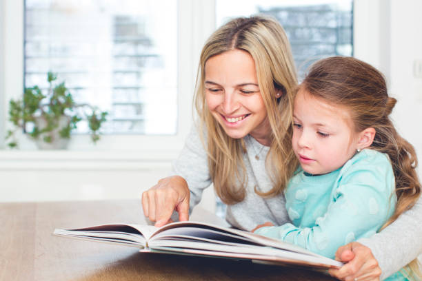 istock beautiful Mother learns to read a book with the daughter 926189586