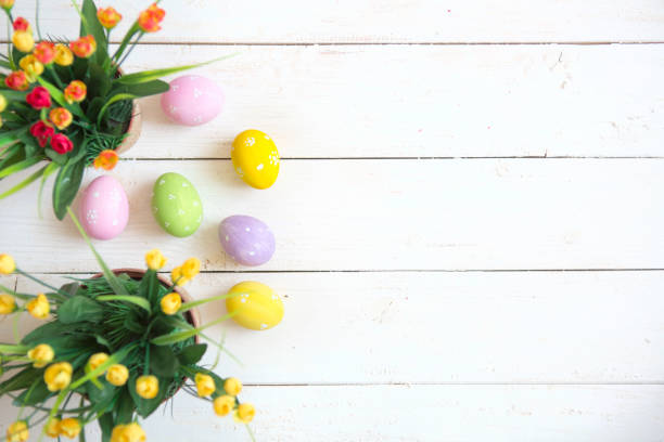 istock Easter eggs with flowers on white wooden background 926189820