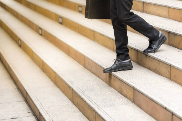 istock Businessman holding a handbag and walking downstairs 926193616