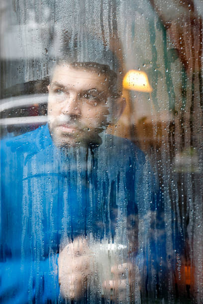istock Portrait of man holding coffee cup by window 926193956