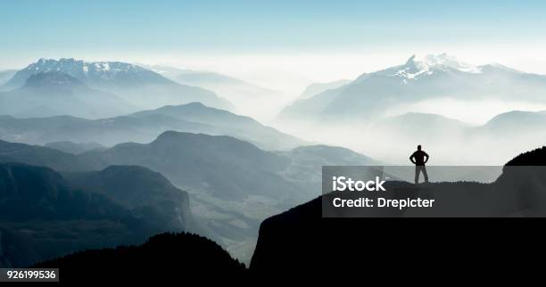 Spectacular Mountain Ranges Silhouettes Man Reaching Summit Enjoying Freedom Stock Photo - Download Image Now