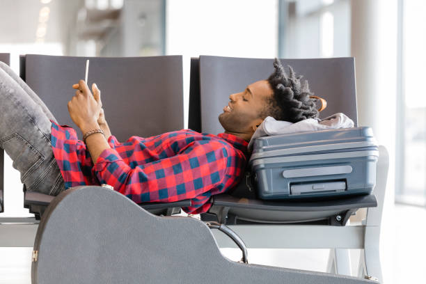 istock Young man waiting for flight in airport lounge 926199742