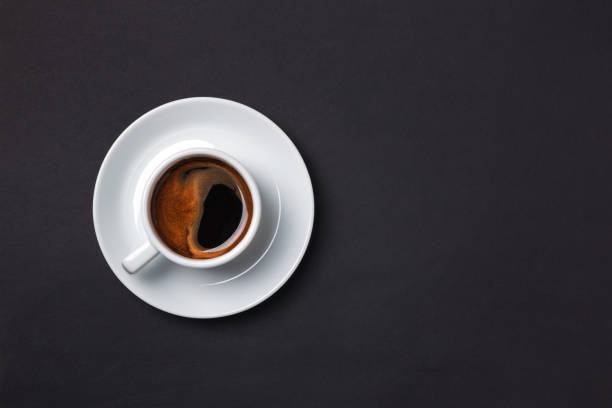 istock Cup of espresso with saucer on brown background. 926203518