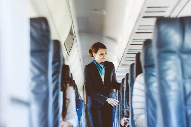 Beautiful air stewardess inside an airplane Beautiful air stewardess inside an airplane. cabin crew stock pictures, royalty-free photos & images