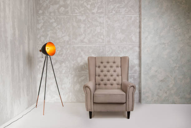 istock Minimalistic gray interior with armchair and vintage lam 926211716