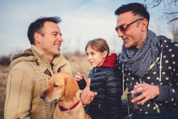 istock Gay parents with daughter and dog 926212840