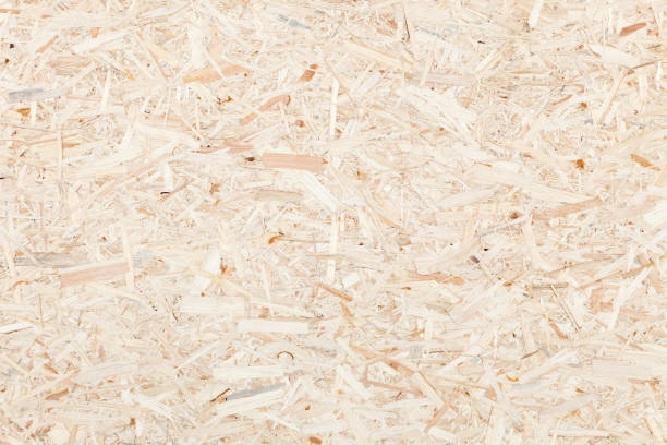 Clean surface of wood particle Board. Texture of compressed wood chippings board. Clean, light surface of wood particle Board. Texture of compressed wood chippings board pressboard stock pictures, royalty-free photos & images