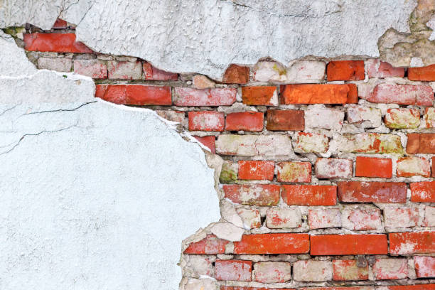 istock Old wall of red brick with loose plaster. 926216472