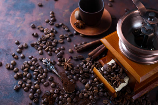 istock Old vintage grinder with roasted coffee beans and grind coffee on stone background. 926220238