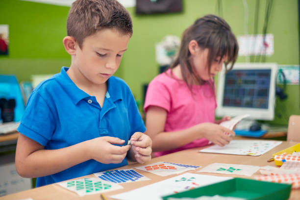 istock Schoolboy with colorful stickers during art class 926226998