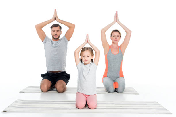 istock athletic family practicing yoga on mats together isolated on white 926234646