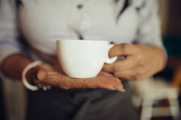 istock Female waitress holding cup of coffee 926237678