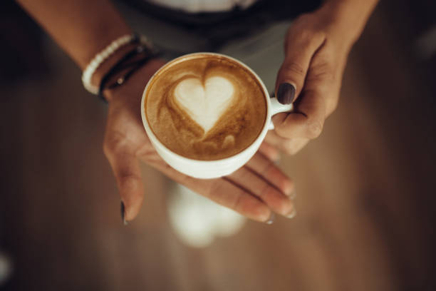 istock Female waitress holding cup of coffee 926238022