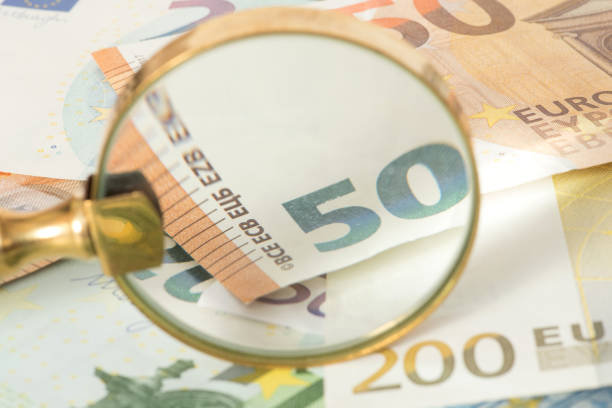 istock Euro banknotes and a magnifying glass 926238154
