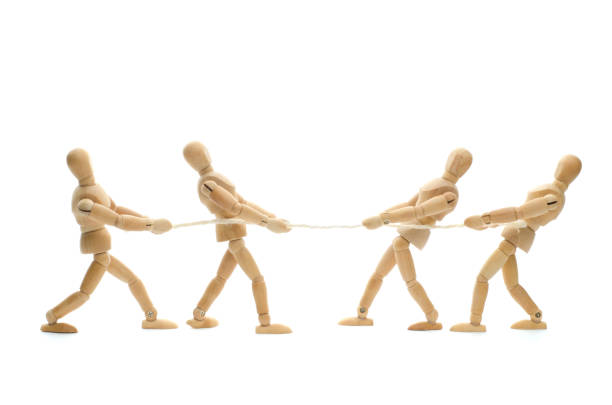 Wooden mannequin and tug of war - pulling on rope