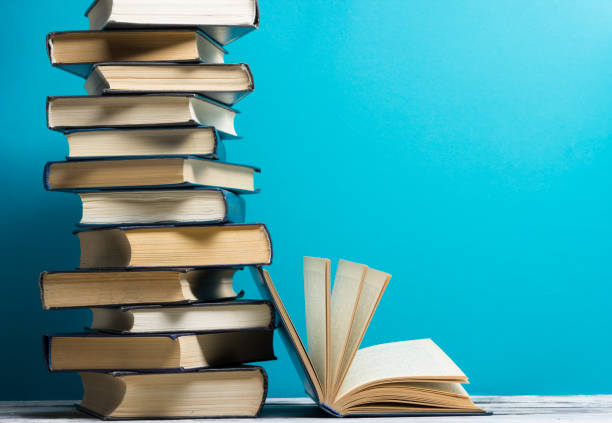 istock Open book, hardback books on wooden table. Back to school. Copy space 926243092