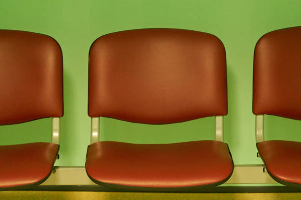 Blue chairs against the wall in a waiting room in the hospital