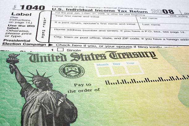 istock Income Tax Form and Refund Check 92624551