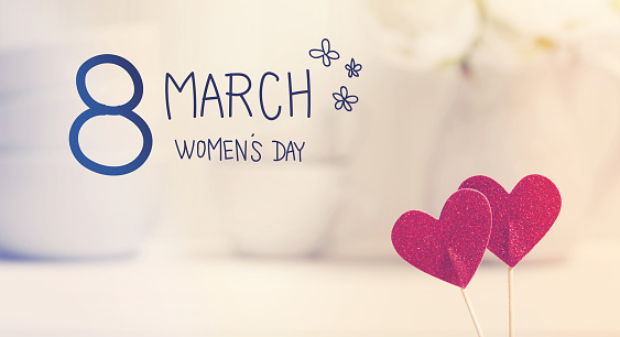 Womens Day message with small red hearts with white dishes