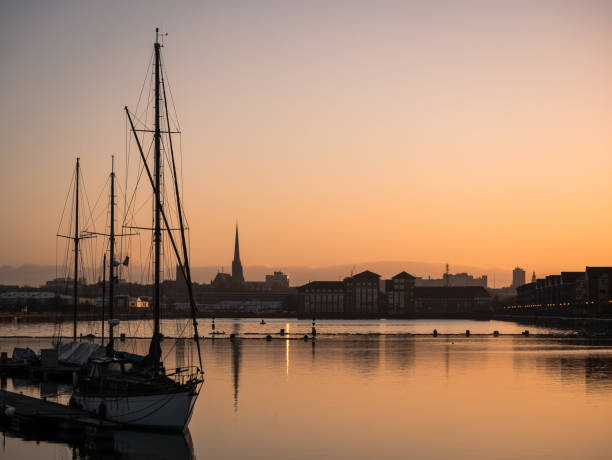Boats on Preston Docks at Sunrise Boats on Preston Docks at Sunrise.  St Walburgs spire in background lancashire photos stock pictures, royalty-free photos & images