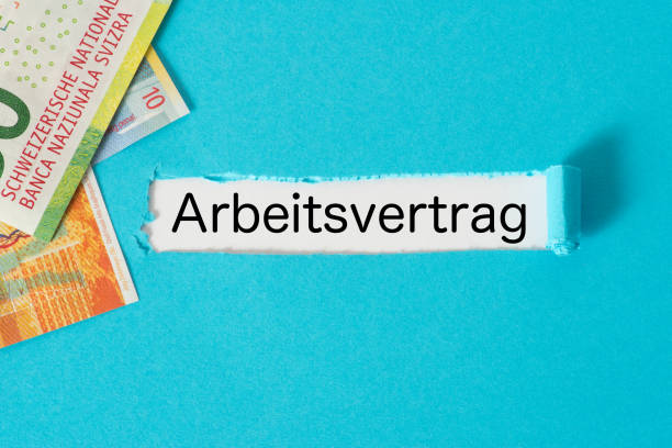 istock Swiss franc banknotes and an employment contract 926250424