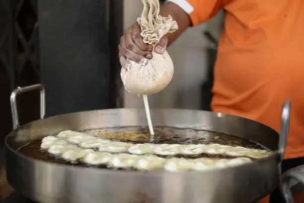 Close-up of Indian delicious jalebi frying in oil pan