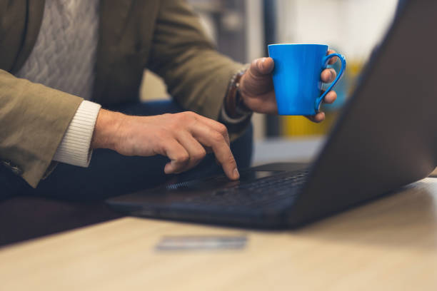 istock Man`s hands, coffee and laptop 926261256