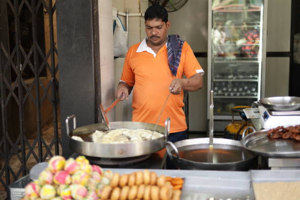 Delicious jalebi frying in oil pan Mumbai, India – March 1, 2018: Close-up of Indian delicious jalebi frying in oil pan india sweets stock pictures, royalty-free photos & images