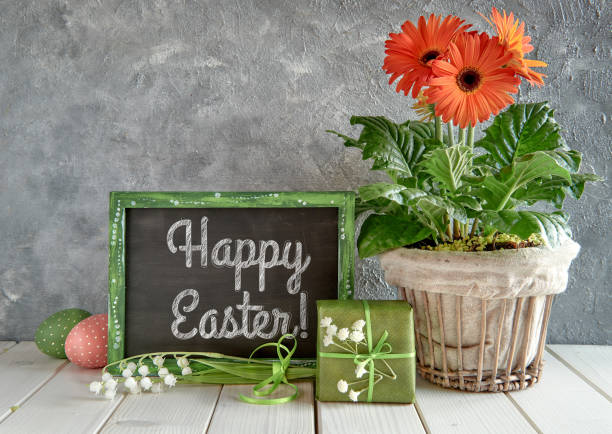 istock Springtime background with an open book, blackboard with text and spring flowers 926264818