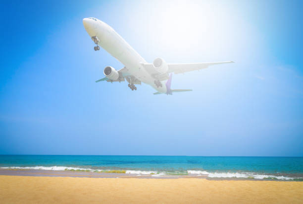 istock Plane flying on blue sky with cloud background over beach and tropical sea. 926265200