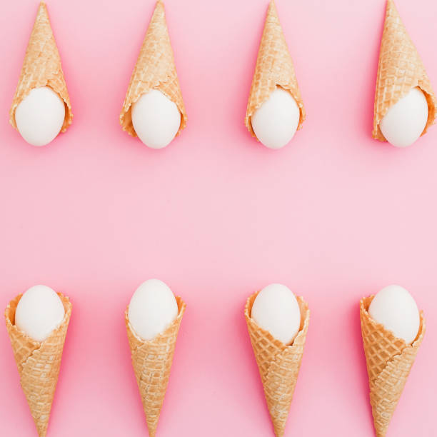istock Frame of Easter white eggs in waffle cone on pastel pink background. Top view, Flat lay. Easter holiday concept. 926267190