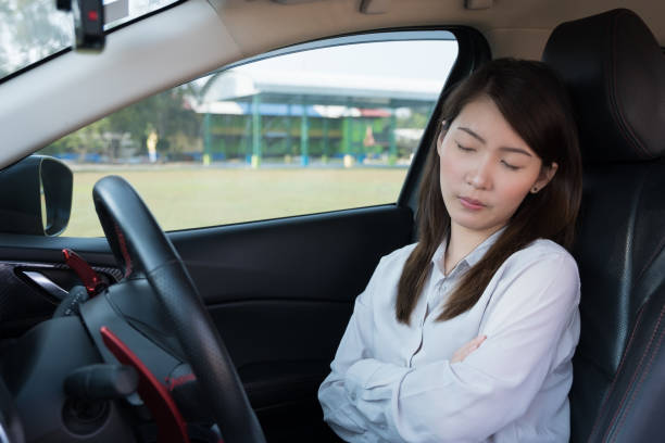 istock Young woman sleeping in car 926268114
