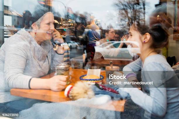Mother And Daughter Eating In A Small Local Bakery Shop Stock Photo - Download Image Now