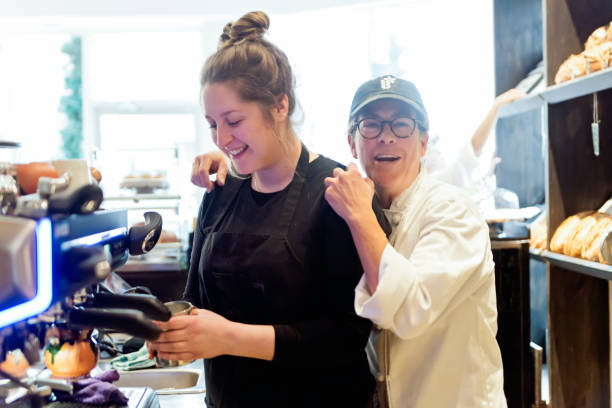 istock Interaction between owner and employee in a small local bakery shop. 926272334