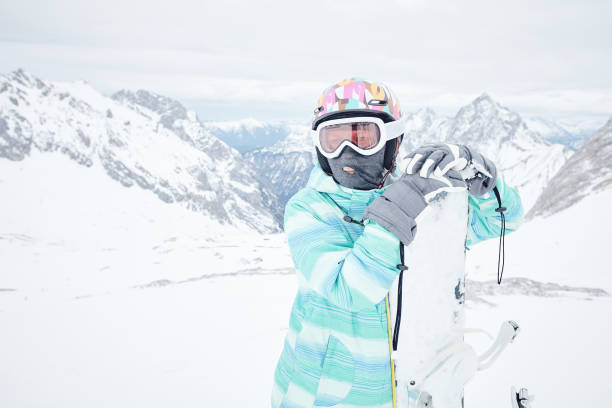 istock Young woman with snowboard 926275260