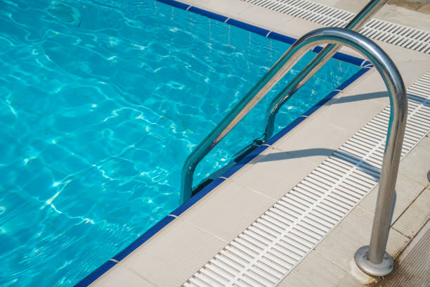 istock Grab bars ladder in the blue swimming pool 926275722