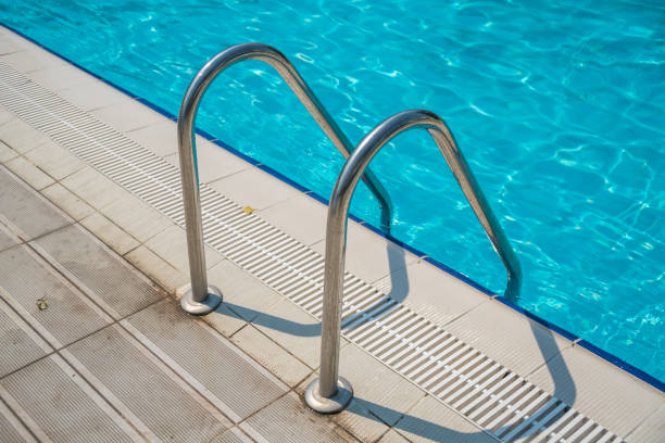 istock Grab bars ladder in the blue swimming pool 926275922