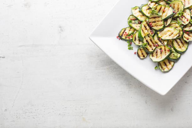istock Zucchini. Grilled zucchini with red spice on white plate 926276068