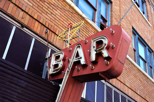 Low Angle View Of Illuminated Bar Sign Hanging On Ceiling