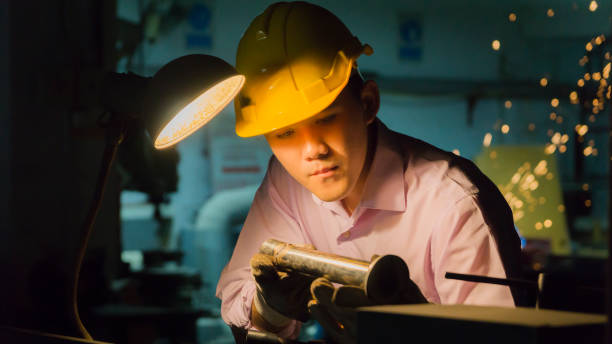 istock worker use bending machine with steel pipe. Metal working concept in low light 926278808