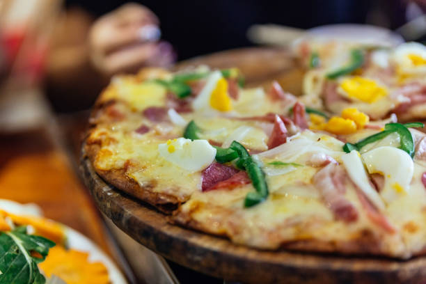 istock Boiled egg cheese pizza that pick slices with stretching cheese at the restaurant in Sa PA, Vietnam. 926283266