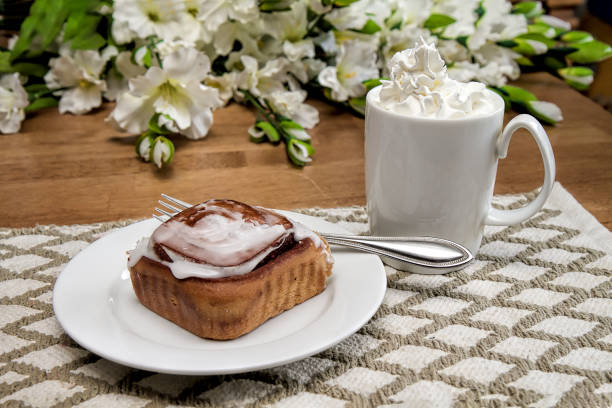 Morning breakfast with cinnamon bun and hot chocolate